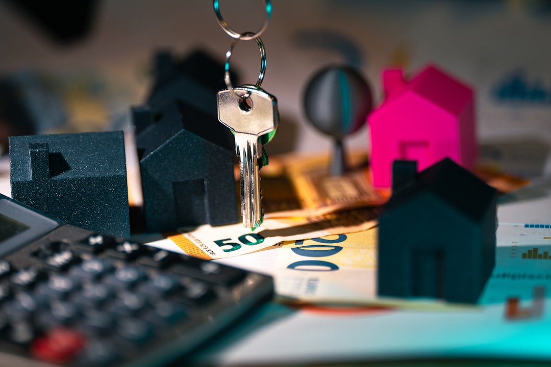 Real estate market finance calculator. Home heys on banknotes documents agreement.